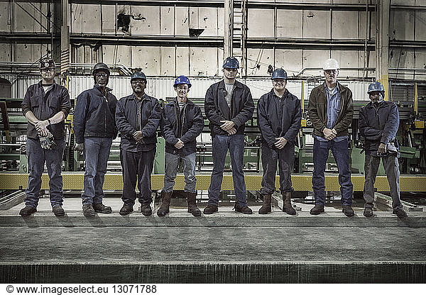 Portrait of confident coworkers in factory warehouse