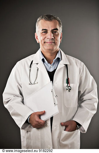 Portrait of confident doctor with clipboard