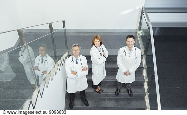 Portrait of confident doctors on stairs