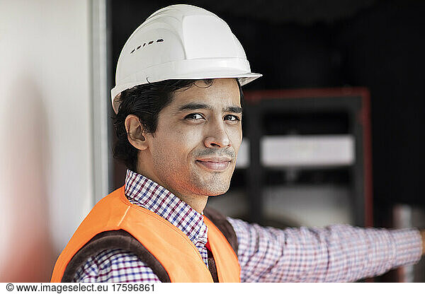 Portrait of confident engineer wearing hardhat