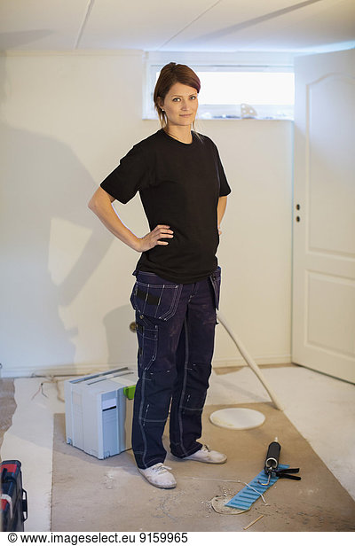 Portrait of confident female carpenter standing at site