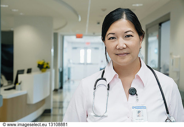 Portrait of confident female doctor with stethoscope in hospital lobby