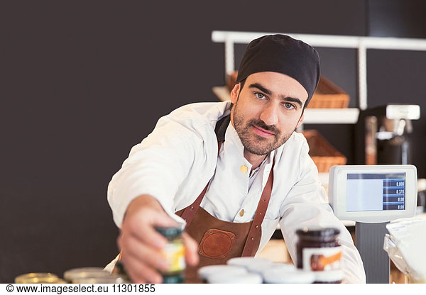 Portrait of confident male owner working in grocery store