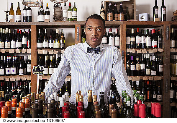 Portrait of confident male Small Business owner standing in wine shop