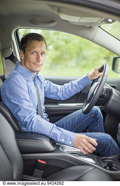 Portrait of confident man sitting in car