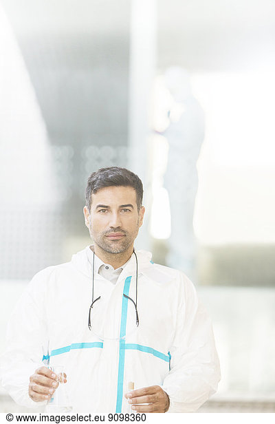 Portrait of confident scientist in clean suit in laboratory