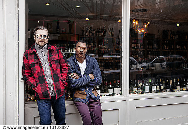 Portrait of confident Small Business owners standing outside wine shop