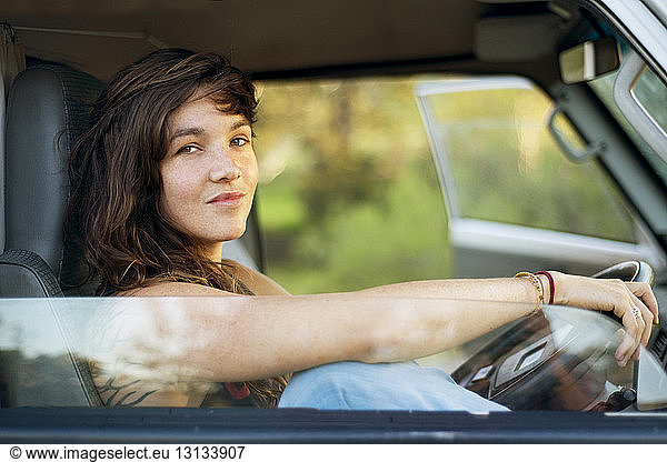 Portrait of confident woman sitting in van