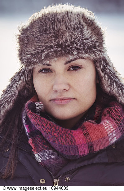 Portrait of confident woman wearing fur hat