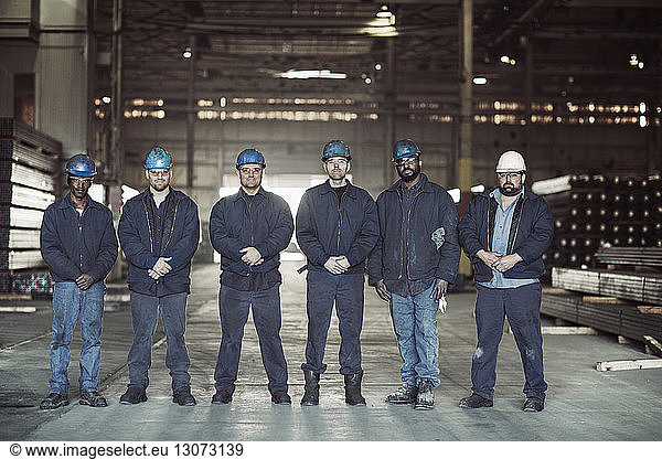 Portrait of confident workers in factory warehouse