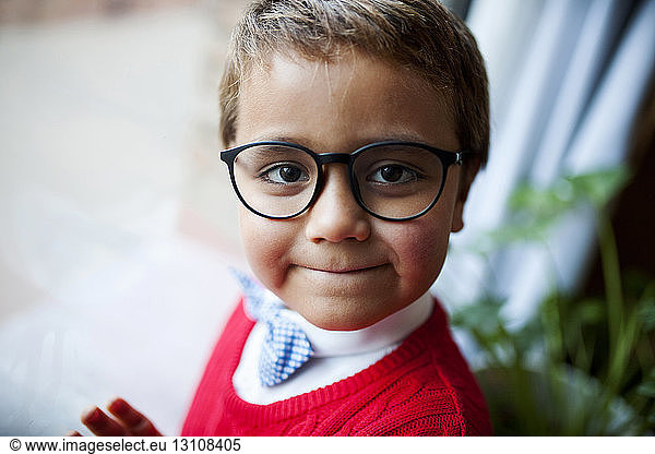 Portrait of cute boy wearing eyeglasses and bow tie