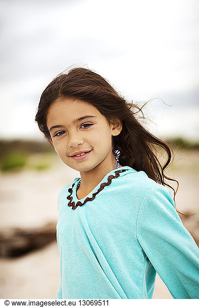 Portrait of cute girl standing against cloudy sky Portrait of cute girl ...