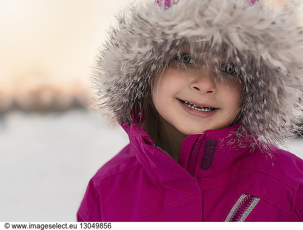 Portrait of cute girl wearing fur coat during winter