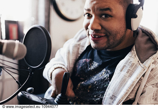 Portrait of disabled musician with headphones in studio
