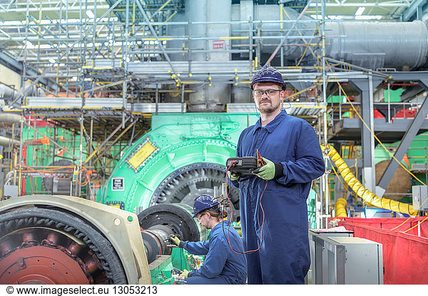 Portrait of engineer in turbine hall of nuclear power station during outage