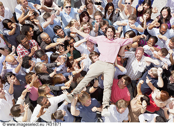 Portrait of enthusiastic man crowd surfing