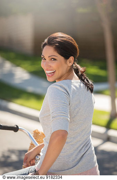 Portrait of enthusiastic woman on bicycle