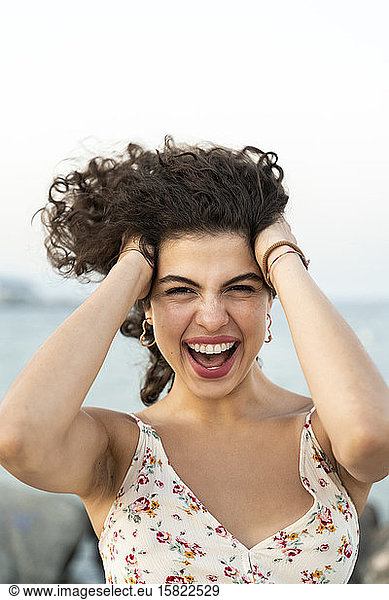 Portrait of excited young woman outdoors