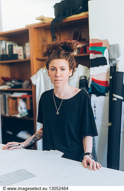 Portrait of fashion designer in her work studio