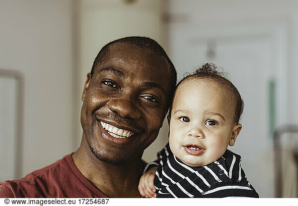 Portrait of father and baby boy at home