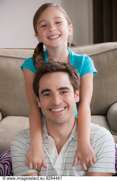 Portrait of father and daughter smiling at camera