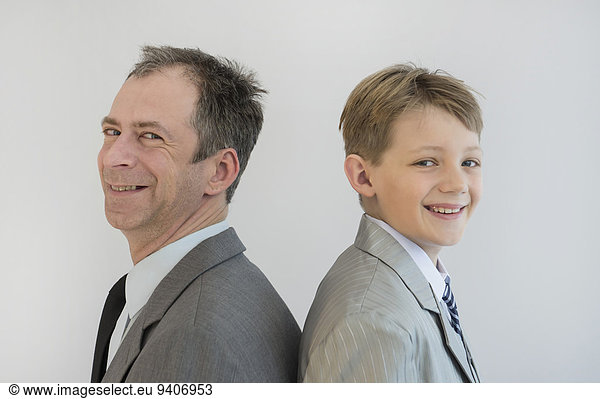 Portrait of father and son smiling  close up