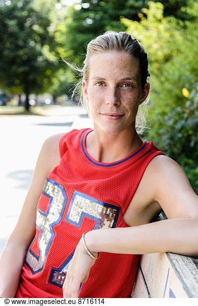 Portrait of female basketball player taking a break in park