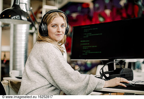 Portrait of female computer programmer sitting in office