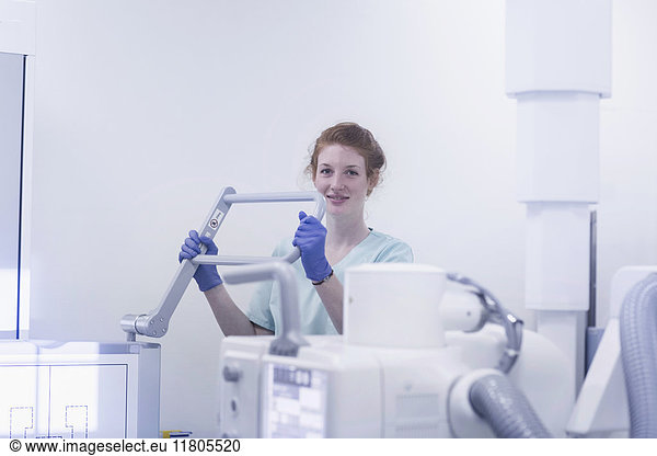 Portrait of female nurse holding part of X-ray equipment