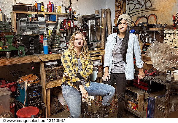Portrait of female owners in auto repair shop