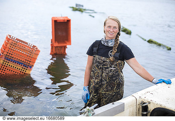 Portrait of Female Shellfish Farmner Standing in Water