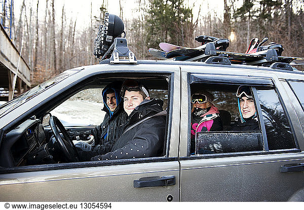 Portrait of female skiers sitting in car