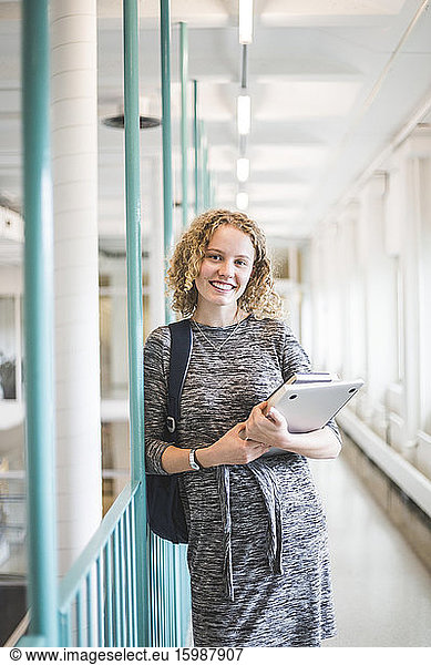 Portrait of female student in corridor of university