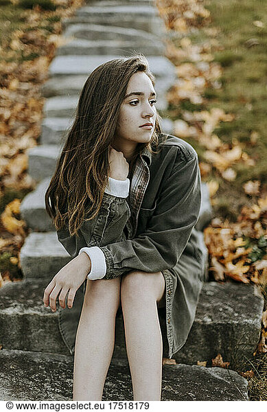 portrait of female teenager looking emotional outside in fall