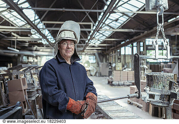 Portrait of foundry worker in brass foundry