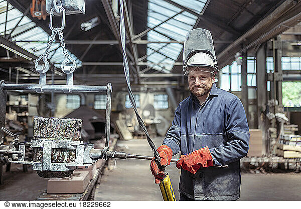 Portrait of foundry worker in brass foundry