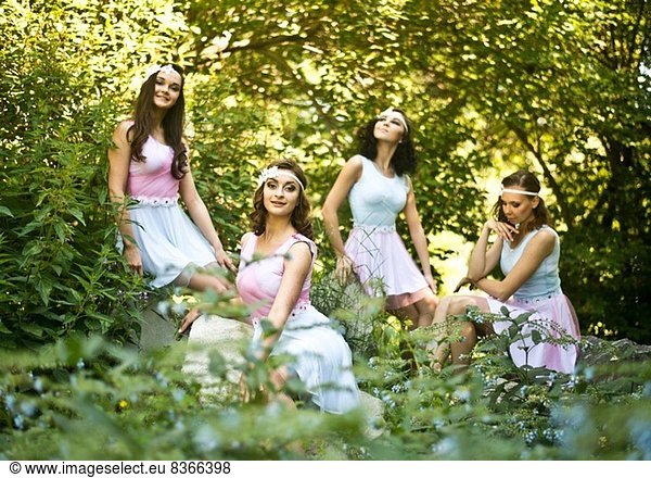 Portrait of four young ballet dancers in woods