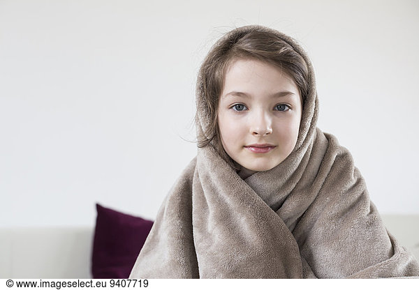 Portrait of girl covered with blanket  close up