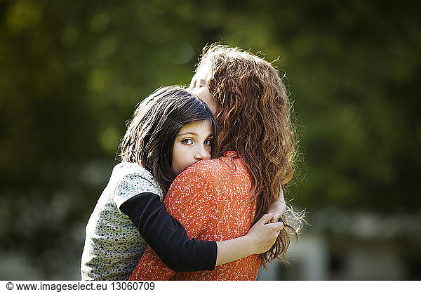 Portrait of girl embracing mother