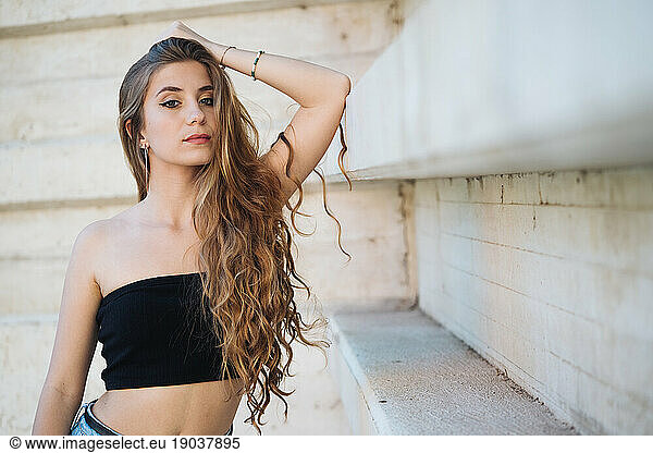 Portrait Of Gorgeous Urban Girl Next To A Concrete Wall.