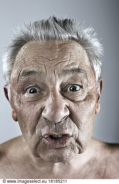 Portrait of grumpy senior man