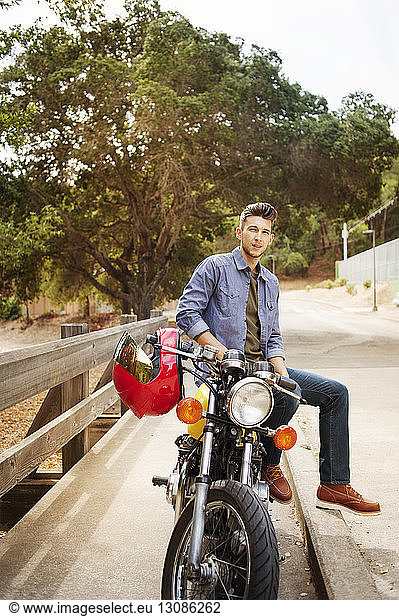 Portrait of handsome man sitting on motorcycle