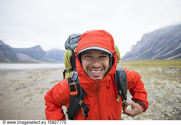 Portrait of happy backpacker in remote location.