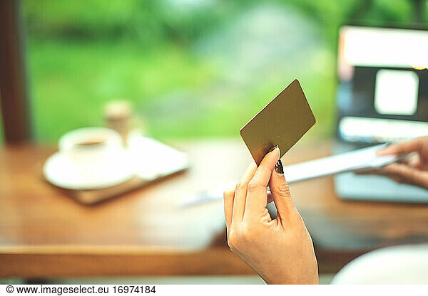 Portrait of happy business woman holding gold credit card A cred