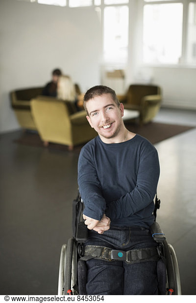 Portrait of happy businessman with cerebral palsy at office lobby