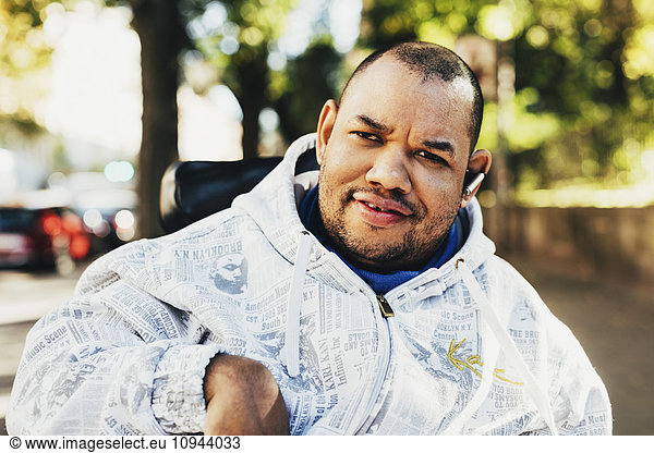 Portrait of happy disabled man wearing jacket outdoors