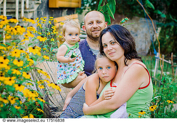 Portrait Of Happy Family In Garden At Home