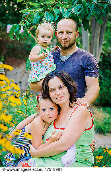 Portrait Of Happy Family In Garden At Home