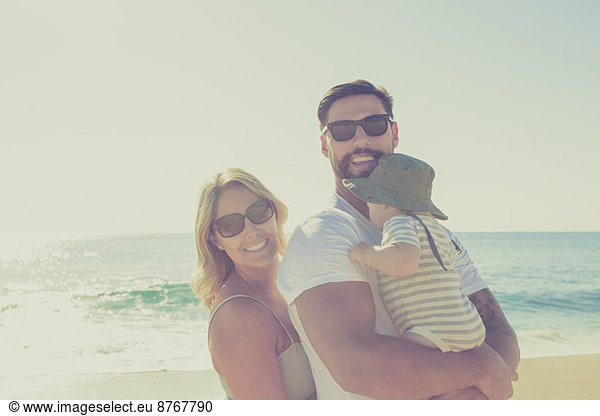 Portrait of happy family on sunny beach