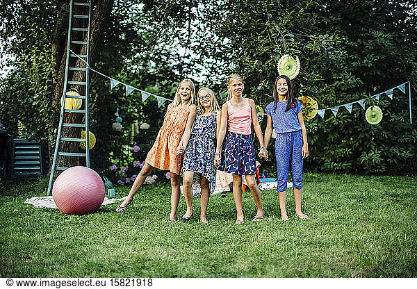 Portrait of happy girls on a birthday party outdoors